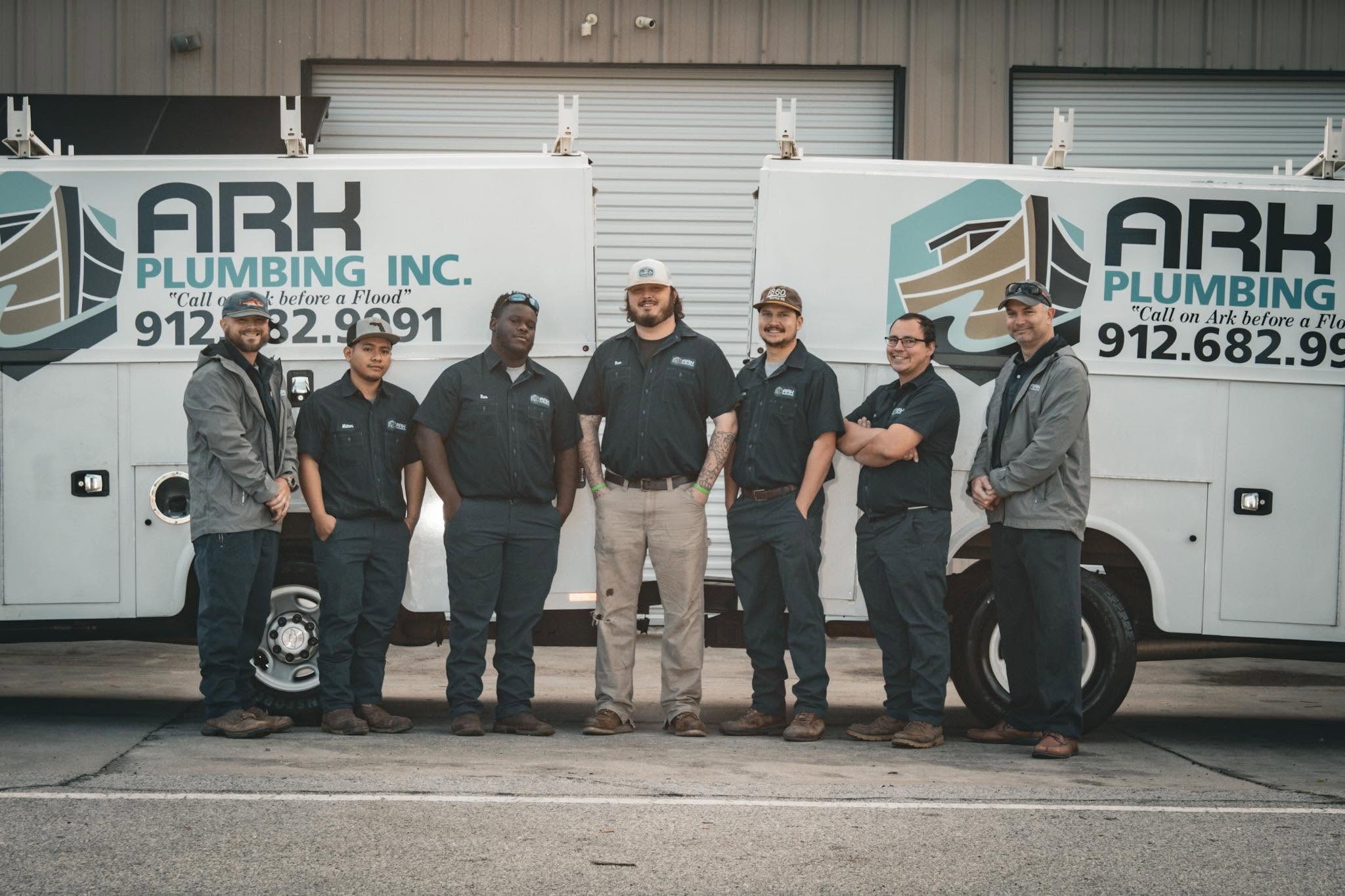The Ark Services team standing in front of Ark service trucks